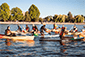 Group of people paddling canoes on water during an exciting adventure with Vancouver Water Adventures