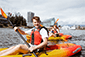 Two people walking on the beach with a kayak, enjoying a Vancouver Water Adventures experience