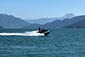 Jet ski cruising on water with mountains in background, Vancouver Water Adventures